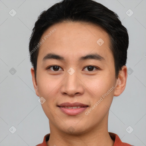 Joyful asian young-adult male with short  black hair and brown eyes