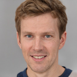 Joyful white adult male with short  brown hair and grey eyes