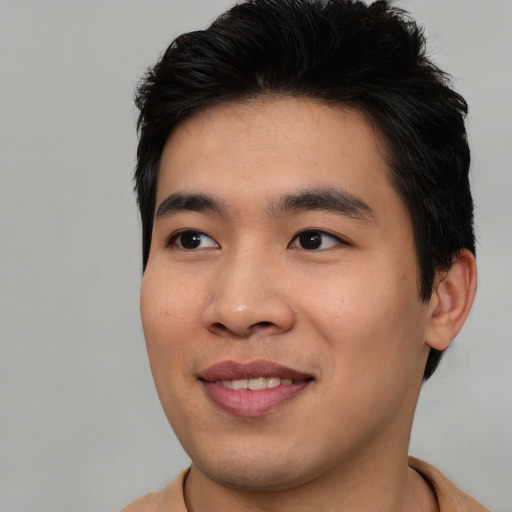 Joyful asian young-adult male with short  brown hair and brown eyes
