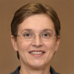 Joyful white adult female with medium  brown hair and brown eyes