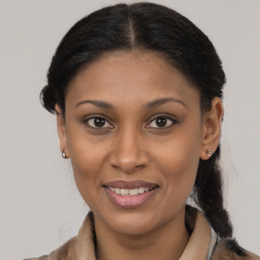 Joyful latino young-adult female with medium  brown hair and brown eyes