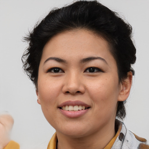 Joyful asian young-adult female with short  brown hair and brown eyes