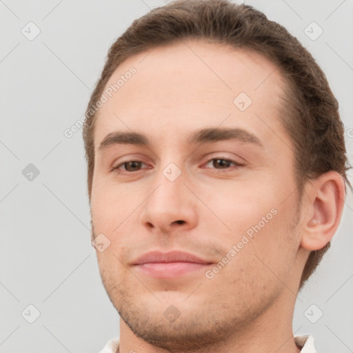 Joyful white young-adult male with short  brown hair and brown eyes