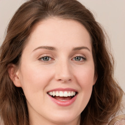 Joyful white young-adult female with long  brown hair and blue eyes