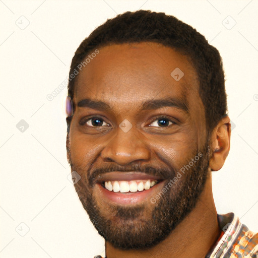 Joyful black young-adult male with short  brown hair and brown eyes