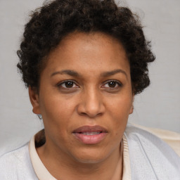 Joyful black adult female with short  brown hair and brown eyes