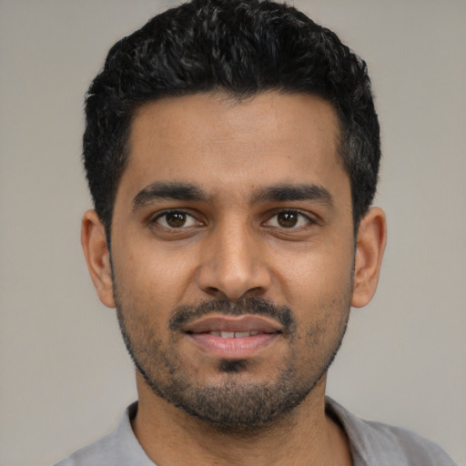 Joyful latino young-adult male with short  black hair and brown eyes