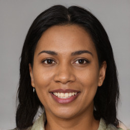 Joyful latino young-adult female with medium  brown hair and brown eyes