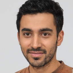 Joyful latino young-adult male with short  black hair and brown eyes