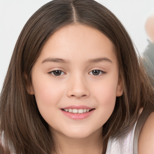 Joyful white child female with long  brown hair and brown eyes