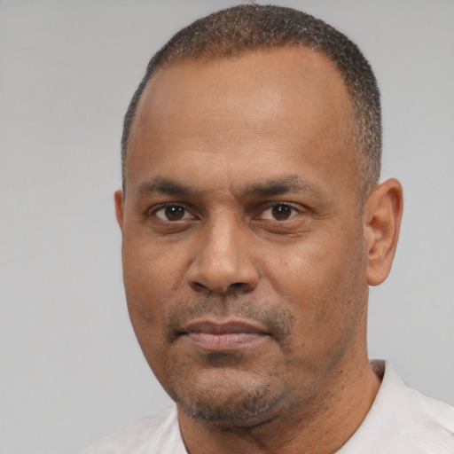 Neutral latino adult male with short  black hair and brown eyes