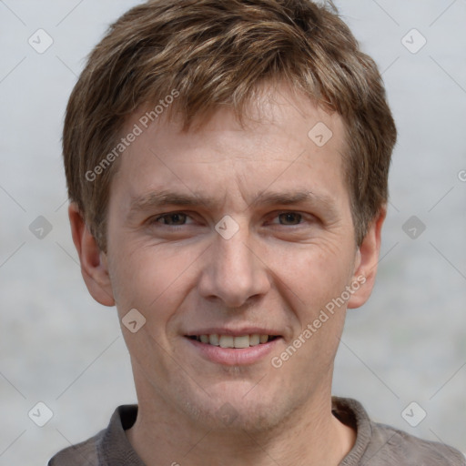 Joyful white adult male with short  brown hair and grey eyes