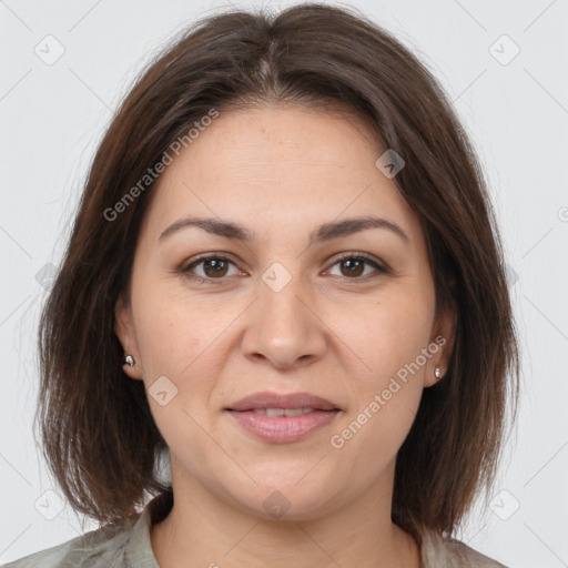 Joyful white adult female with medium  brown hair and brown eyes