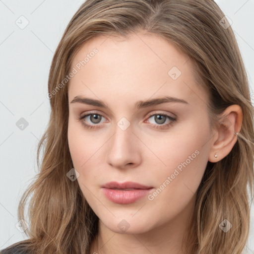 Joyful white young-adult female with long  brown hair and blue eyes