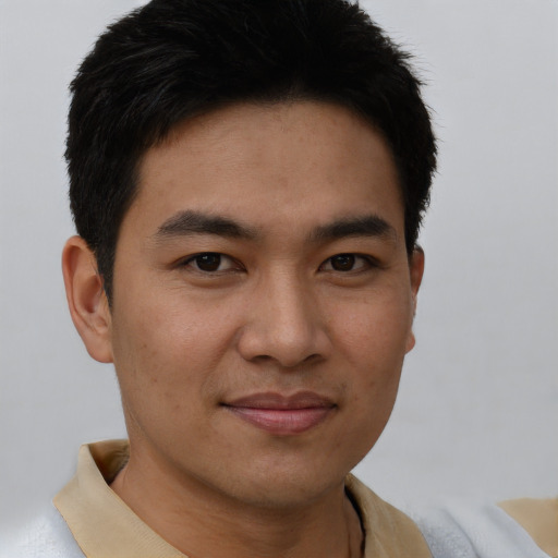 Joyful asian young-adult male with short  brown hair and brown eyes