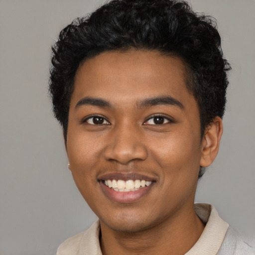Joyful black young-adult male with short  black hair and brown eyes