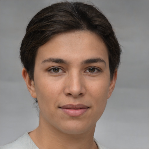 Joyful white young-adult female with short  brown hair and brown eyes