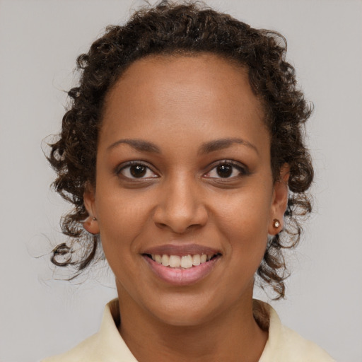 Joyful black young-adult female with medium  brown hair and brown eyes