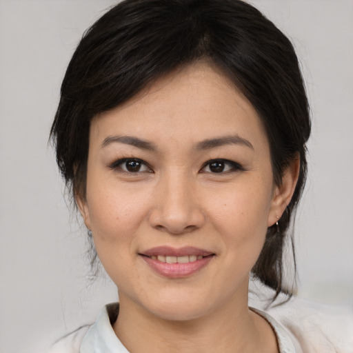 Joyful asian young-adult female with medium  brown hair and brown eyes