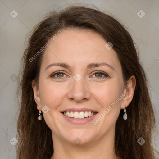 Joyful white adult female with long  brown hair and grey eyes