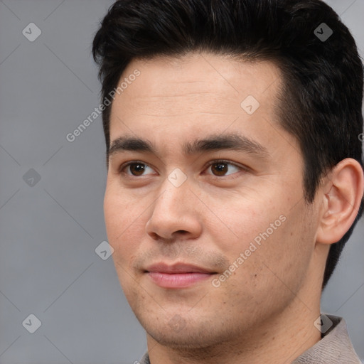 Joyful asian young-adult male with short  black hair and brown eyes