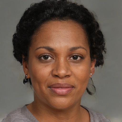 Joyful black adult female with short  brown hair and brown eyes