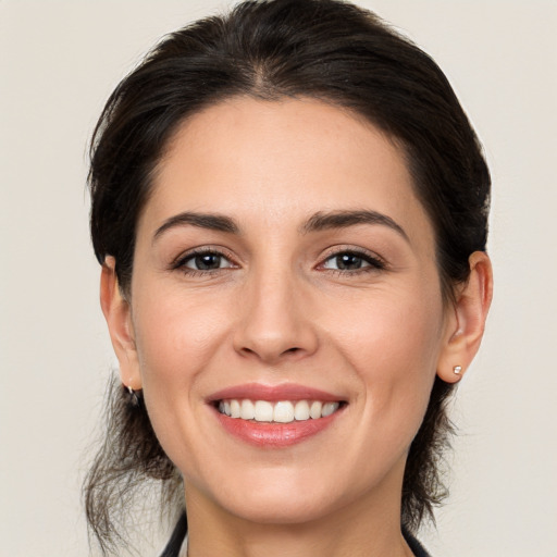 Joyful white young-adult female with medium  brown hair and brown eyes