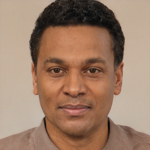 Joyful latino adult male with short  black hair and brown eyes