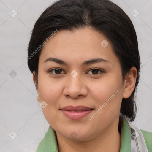 Joyful latino young-adult female with medium  brown hair and brown eyes