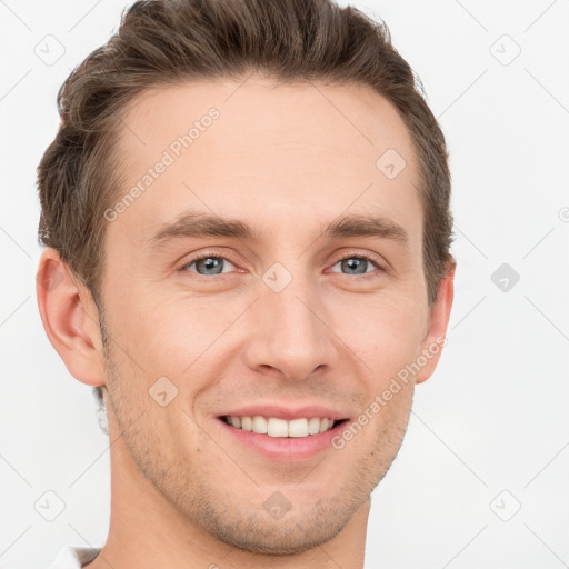 Joyful white young-adult male with short  brown hair and grey eyes