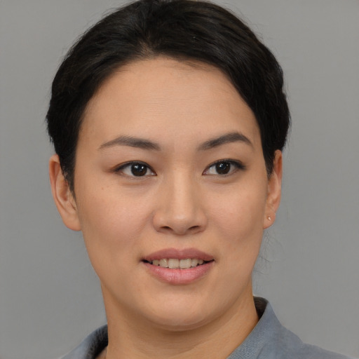 Joyful asian young-adult female with short  black hair and brown eyes