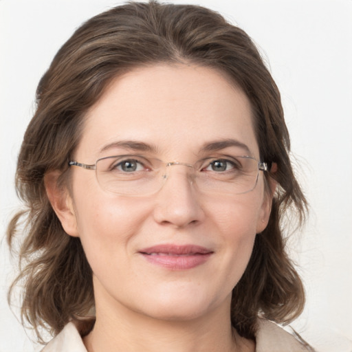 Joyful white adult female with medium  brown hair and grey eyes