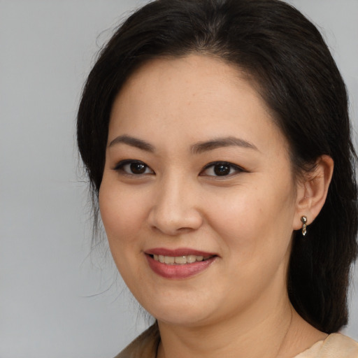 Joyful asian young-adult female with medium  brown hair and brown eyes