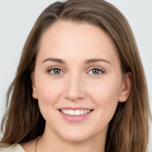 Joyful white young-adult female with long  brown hair and grey eyes