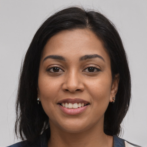 Joyful latino young-adult female with long  brown hair and brown eyes