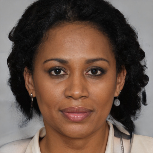 Joyful latino adult female with medium  brown hair and brown eyes