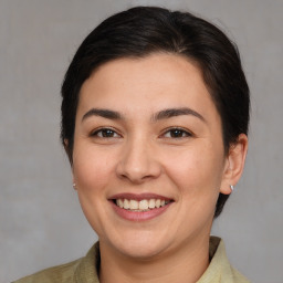 Joyful white young-adult female with medium  brown hair and brown eyes