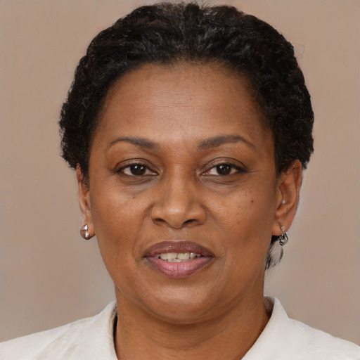 Joyful black adult female with short  brown hair and brown eyes
