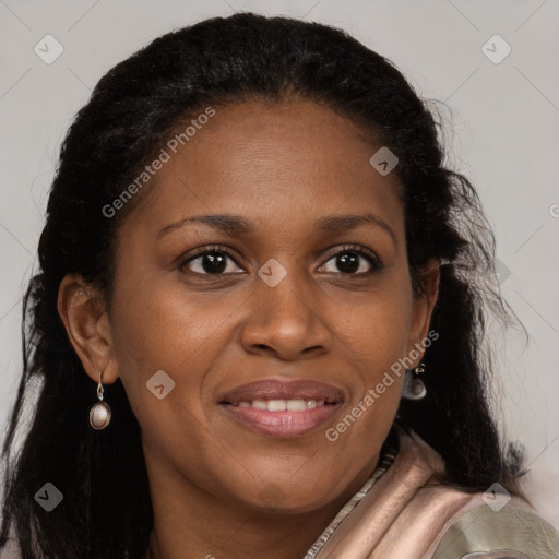 Joyful black young-adult female with long  brown hair and brown eyes