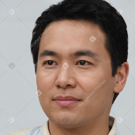 Joyful asian young-adult male with short  brown hair and brown eyes