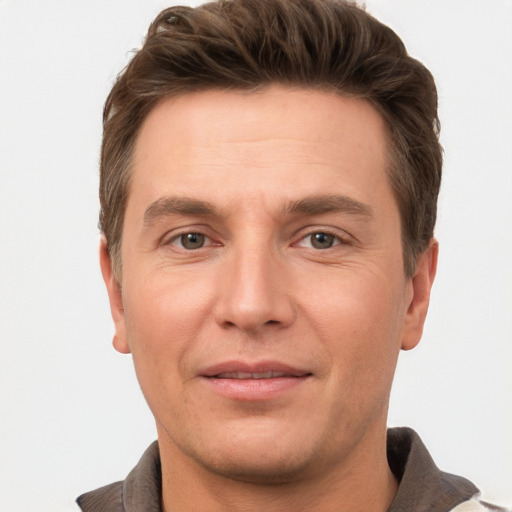 Joyful white adult male with short  brown hair and grey eyes