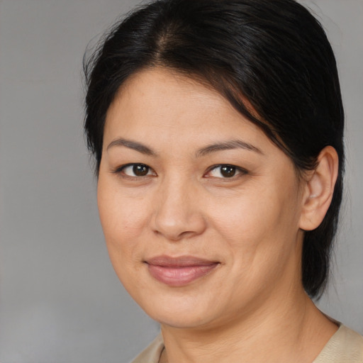 Joyful asian adult female with medium  brown hair and brown eyes