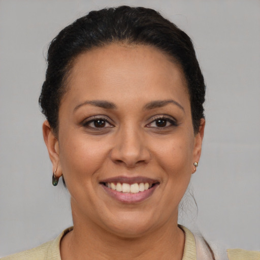 Joyful latino adult female with short  brown hair and brown eyes