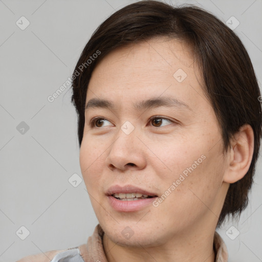 Joyful asian young-adult male with medium  brown hair and brown eyes