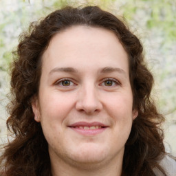 Joyful white young-adult female with long  brown hair and green eyes