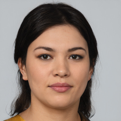 Joyful latino young-adult female with medium  black hair and brown eyes