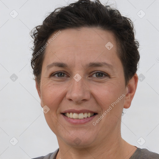 Joyful white adult female with short  brown hair and brown eyes