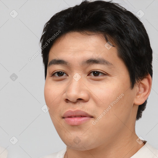 Joyful asian young-adult male with short  black hair and brown eyes
