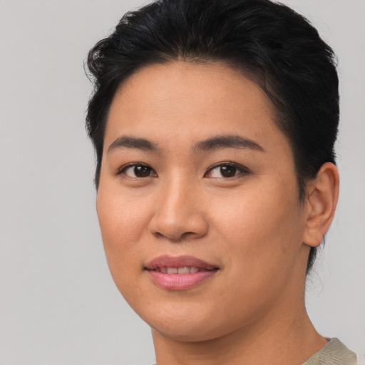 Joyful asian young-adult female with short  brown hair and brown eyes