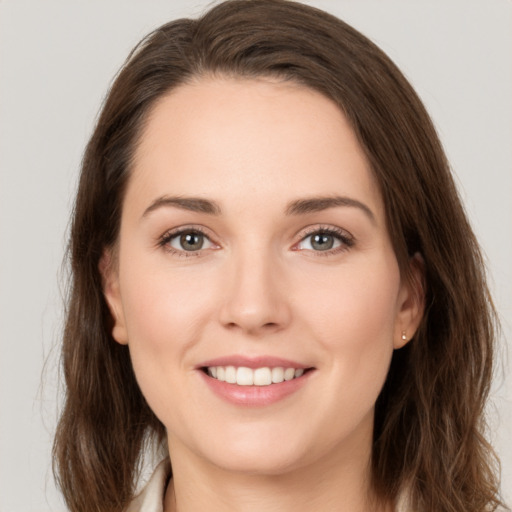 Joyful white young-adult female with long  brown hair and green eyes